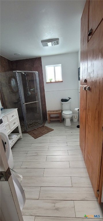 101 E Saint Louis Ave, Seadrift, TX 77983 - bathroom featuring a stall shower, toilet, and wood tiled floors