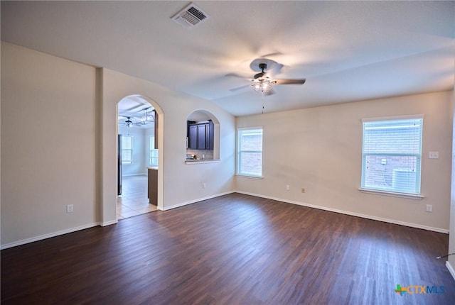 6409 Katy Creek Ln, Killeen, TX 76549 - spare room featuring ceiling fan, dark wood-style flooring, baseboards, and arched walkways