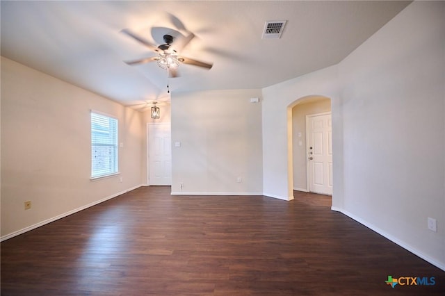 6409 Katy Creek Ln, Killeen, TX 76549 - unfurnished room with a ceiling fan, arched walkways, dark wood-type flooring, and baseboards