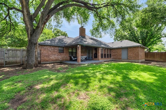 312 Beaver Loop, Temple, TX 76502 - rear view of house featuring brick siding, a patio area, a fenced backyard, and a chimney
