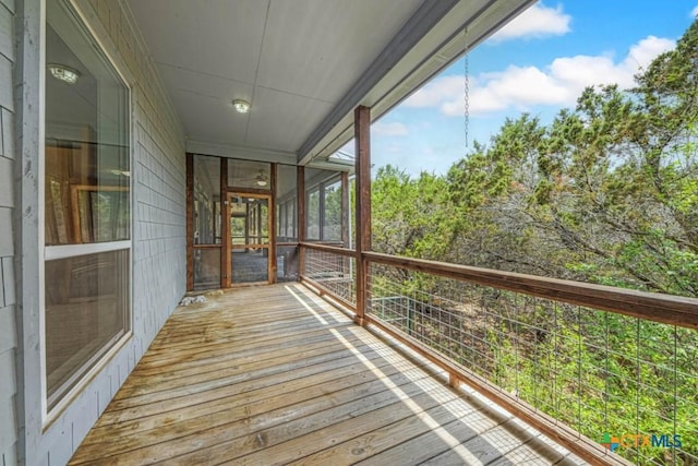 wooden deck with a sunroom