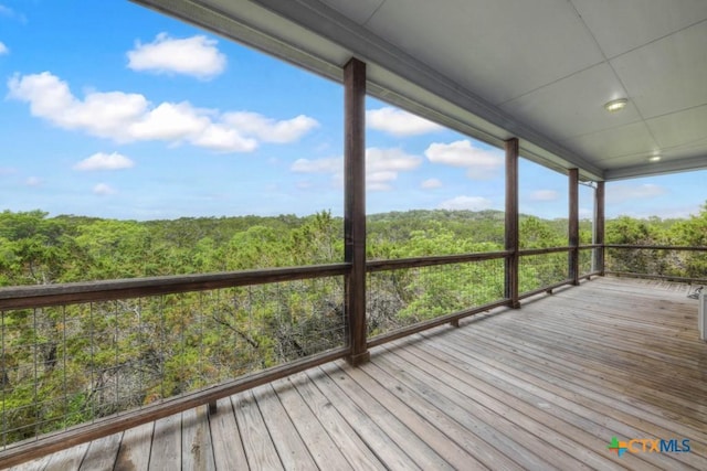 wooden deck featuring a wooded view