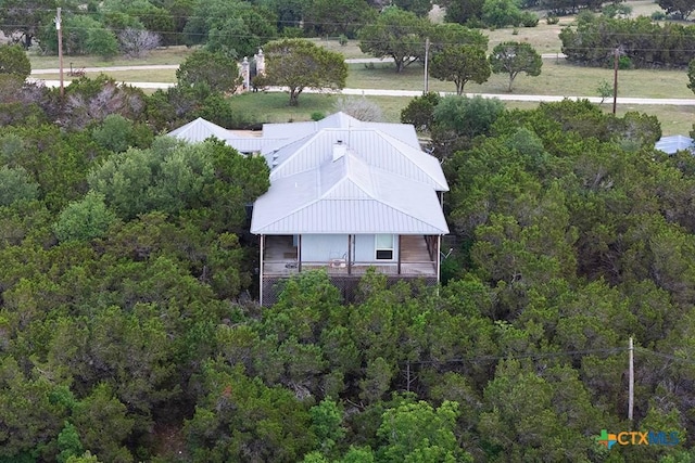 drone / aerial view with a wooded view