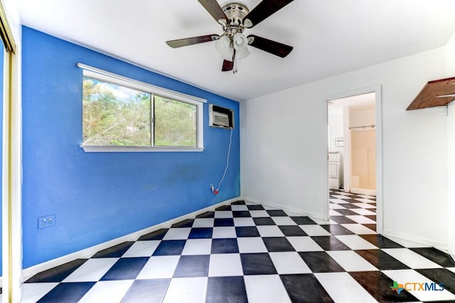 spare room with tile patterned floors, baseboards, a ceiling fan, and an AC wall unit
