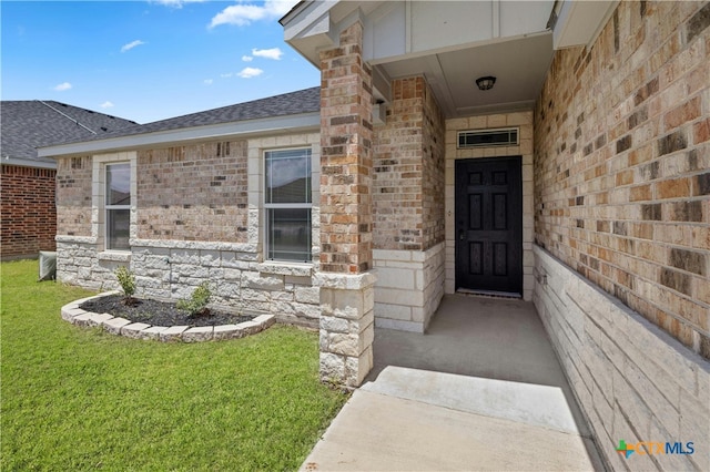 doorway to property with a lawn