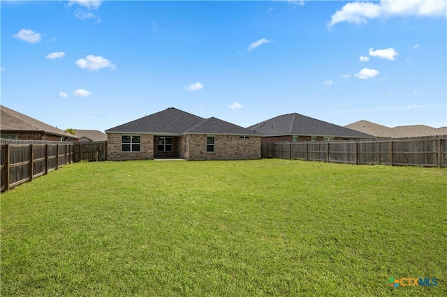 rear view of house with a yard