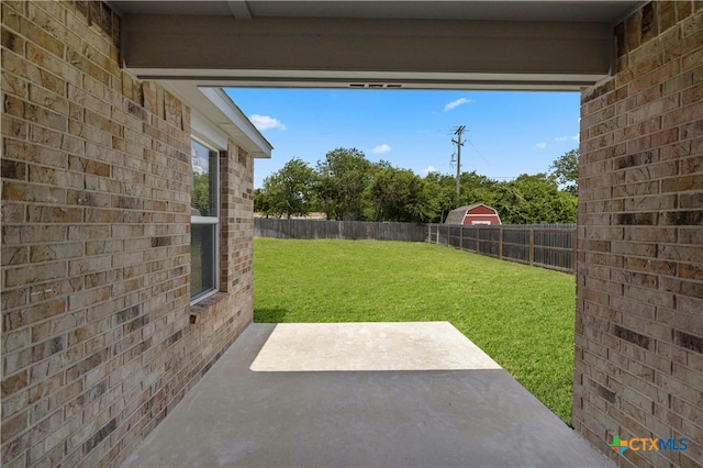 view of yard with a patio and a storage shed