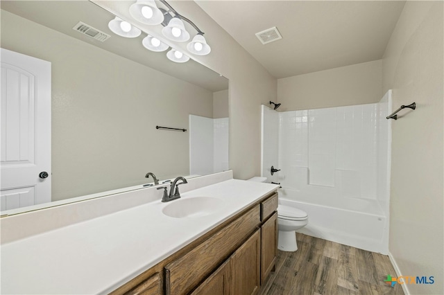 full bathroom with toilet, vanity, wood-type flooring, and  shower combination