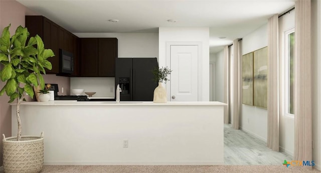 kitchen with light carpet, black fridge, sink, kitchen peninsula, and dark brown cabinetry