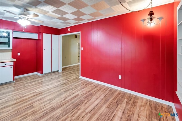 unfurnished dining area with ceiling fan and wood finished floors