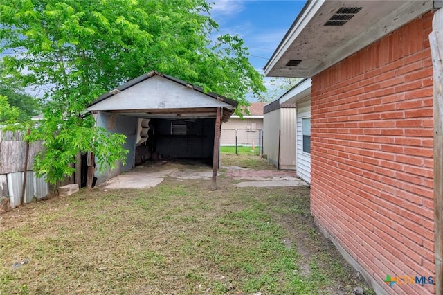 view of yard with fence and an outdoor structure