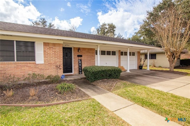 ranch-style house with a garage, brick siding, and driveway