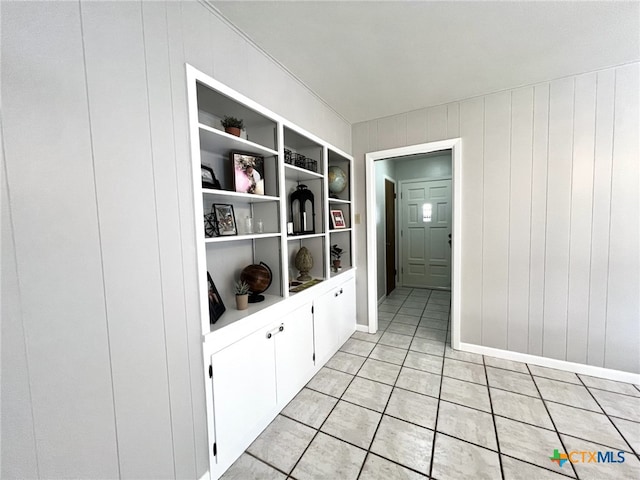 interior space with light tile patterned floors and built in features