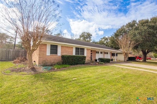 single story home featuring brick siding, an attached garage, driveway, and a front yard
