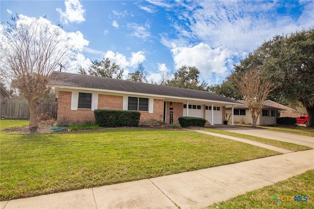 ranch-style home featuring a garage, brick siding, concrete driveway, fence, and a front yard