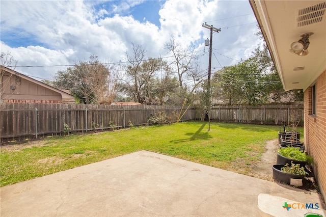 view of yard with a patio area and a fenced backyard