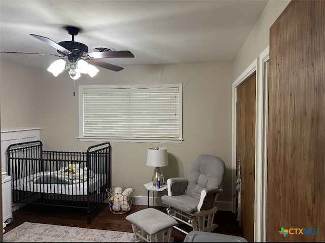 2701 College Dr, Victoria, TX 77901 - bedroom featuring wood finished floors, a crib, and ceiling fan