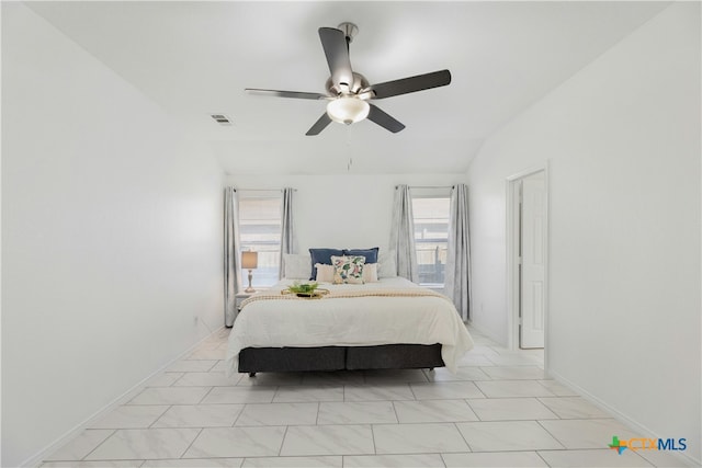 bedroom with multiple windows, lofted ceiling, and ceiling fan