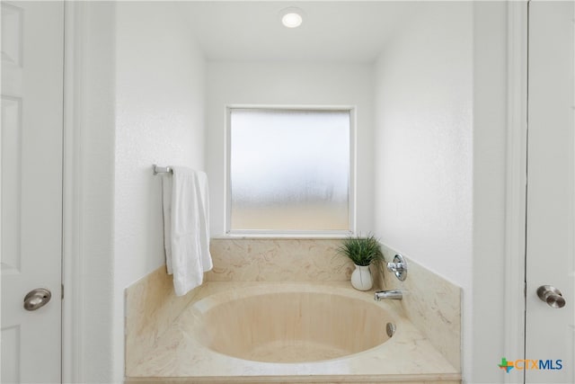bathroom with a tub