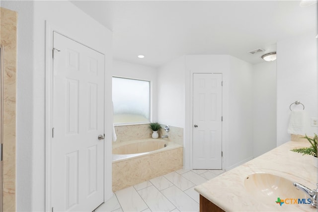bathroom with vanity and a bathtub