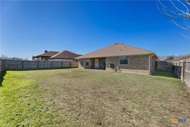 rear view of property featuring a yard