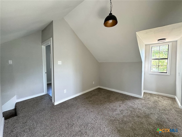 additional living space with carpet flooring and vaulted ceiling