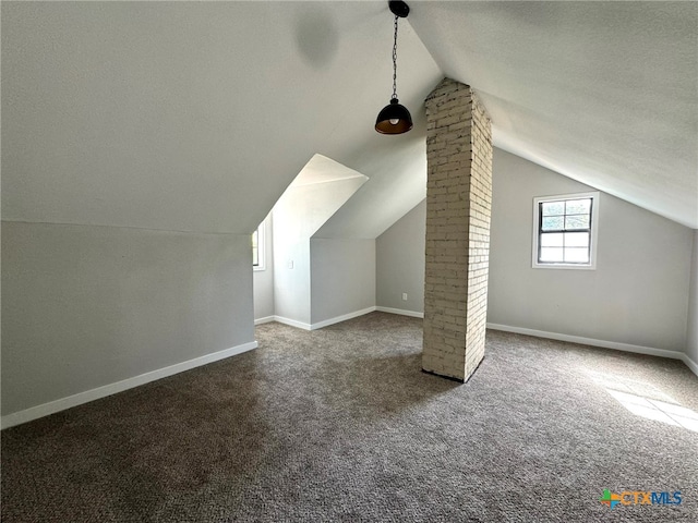 bonus room with carpet flooring, a textured ceiling, and vaulted ceiling