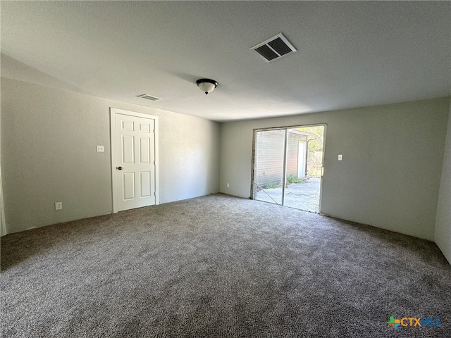 carpeted empty room with a textured ceiling