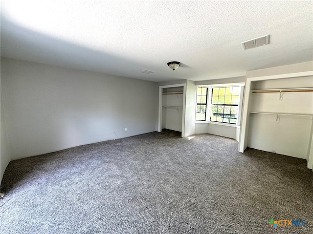 unfurnished bedroom with carpet flooring and a textured ceiling