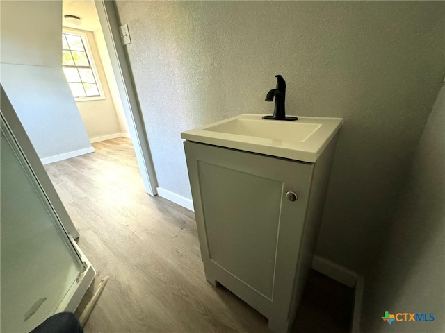 bathroom featuring hardwood / wood-style floors and vanity