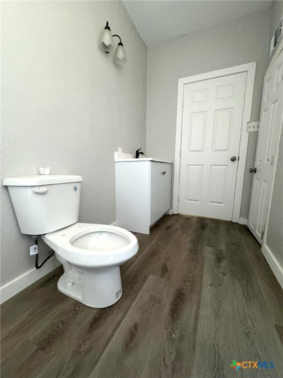 bathroom featuring hardwood / wood-style floors and toilet