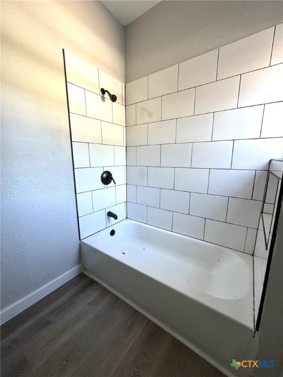 bathroom featuring tiled shower / bath combo and hardwood / wood-style flooring