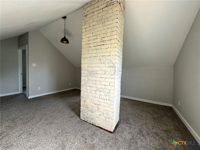 additional living space featuring dark colored carpet and vaulted ceiling