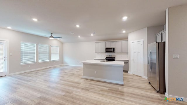 4023 Illian Cv, Killeen, TX 76542 - kitchen with appliances with stainless steel finishes, a sink, ceiling fan, light countertops, and open floor plan