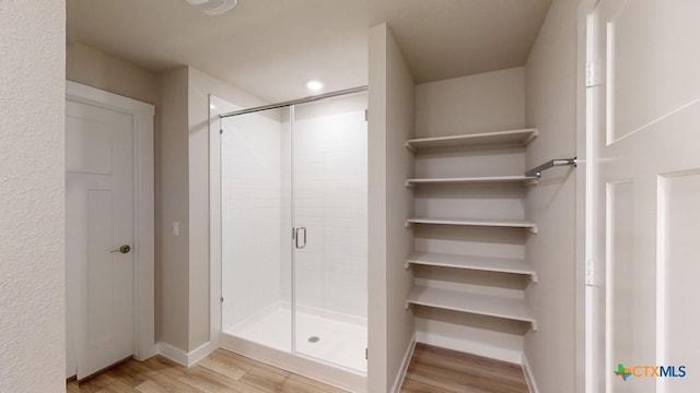 4023 Illian Cv, Killeen, TX 76542 - bathroom featuring wood finished floors, baseboards, and a stall shower
