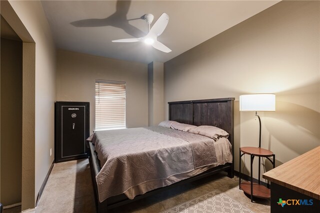 bedroom with ceiling fan and light colored carpet