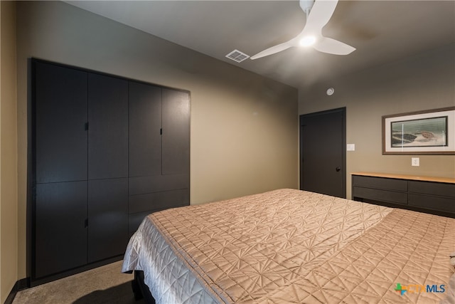 carpeted bedroom featuring ceiling fan and a closet