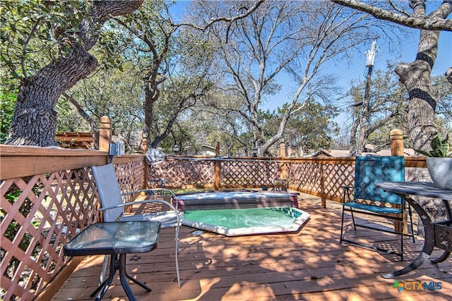 wooden deck with hot tub deck surround