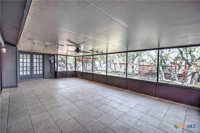 spare room with a textured ceiling, ceiling fan, tile patterned flooring, french doors, and track lighting