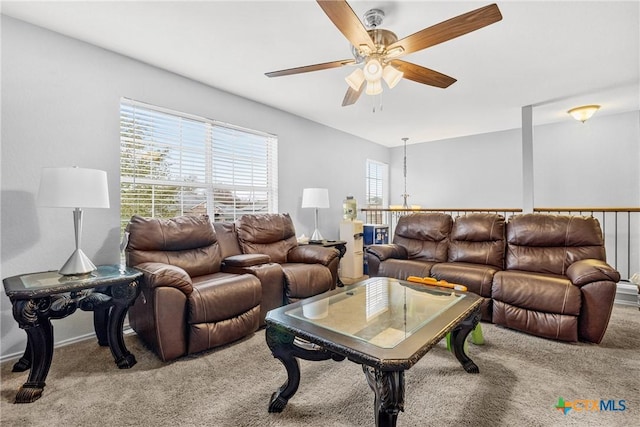 carpeted living area featuring ceiling fan