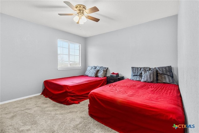 bedroom with carpet, a ceiling fan, and baseboards