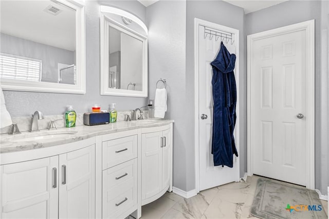 bathroom featuring double vanity, marble finish floor, visible vents, and a sink