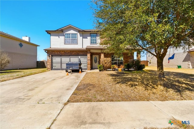 view of front of property with an attached garage, concrete driveway, and brick siding