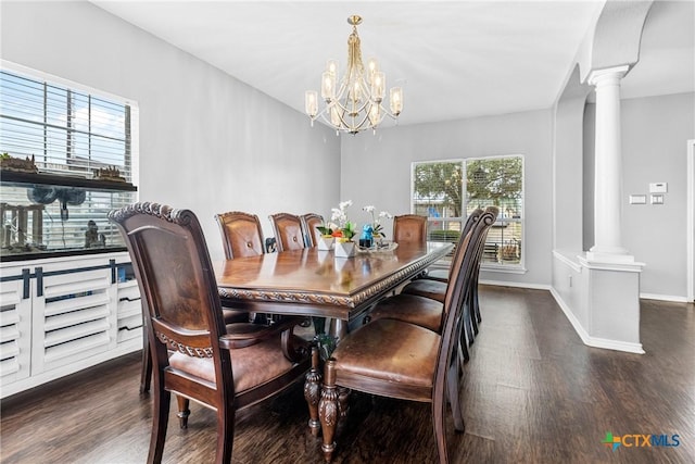 dining room with decorative columns, baseboards, and wood finished floors