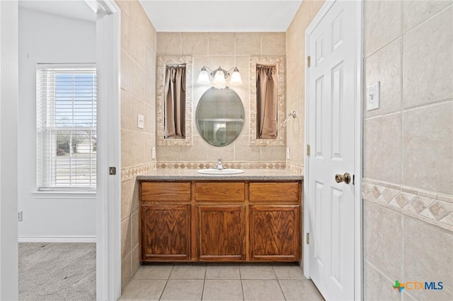 bathroom featuring tile patterned flooring, tile walls, and vanity