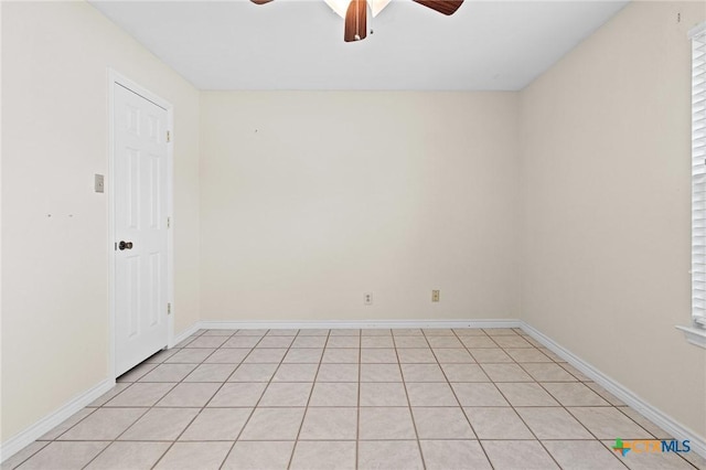 empty room with a ceiling fan and baseboards