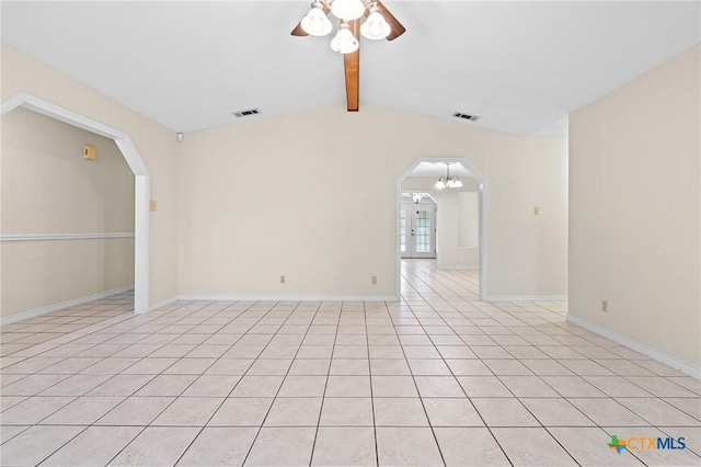 empty room with arched walkways, vaulted ceiling with beams, visible vents, and a ceiling fan