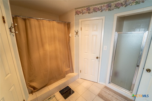 bathroom with tile patterned flooring and a shower with shower curtain