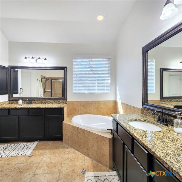 555 Solms Frst, New Braunfels, TX 78132 - bathroom featuring a bath, vaulted ceiling, two vanities, and a tile shower