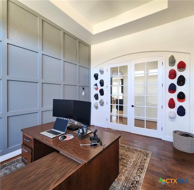 555 Solms Frst, New Braunfels, TX 78132 - office area featuring french doors, dark wood finished floors, a decorative wall, and a raised ceiling